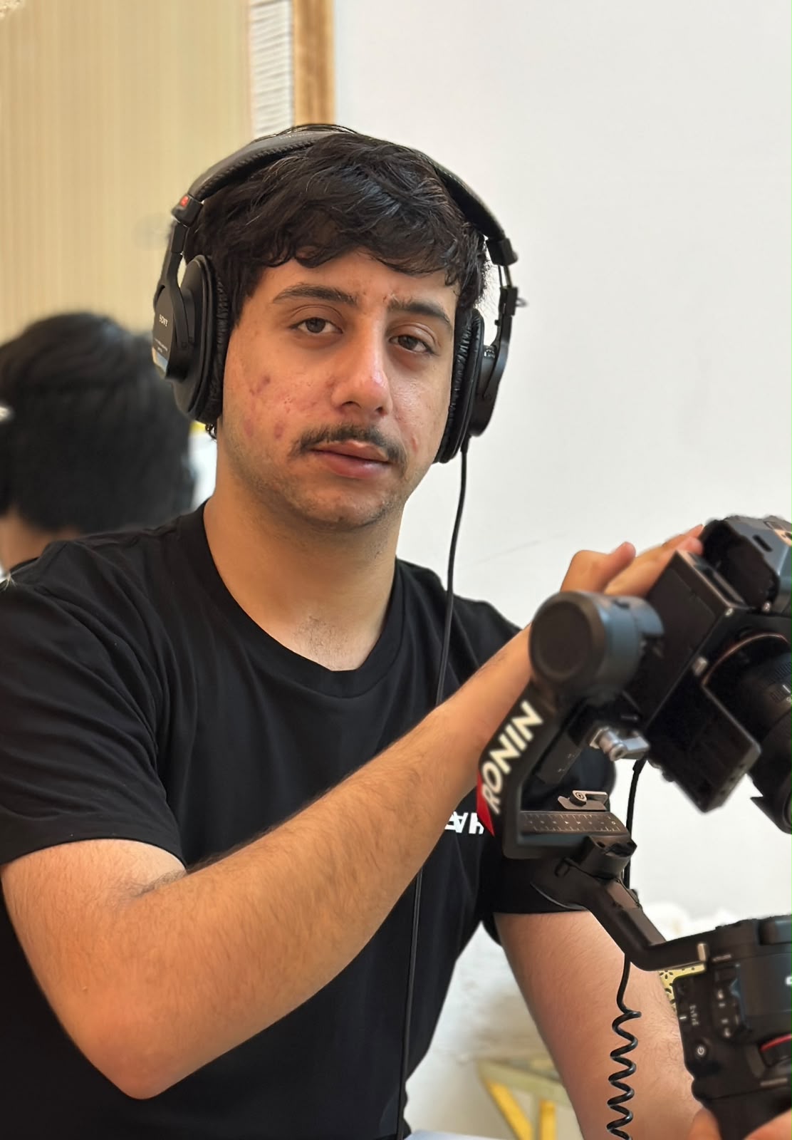 Mohammad Khaddam holding a camera